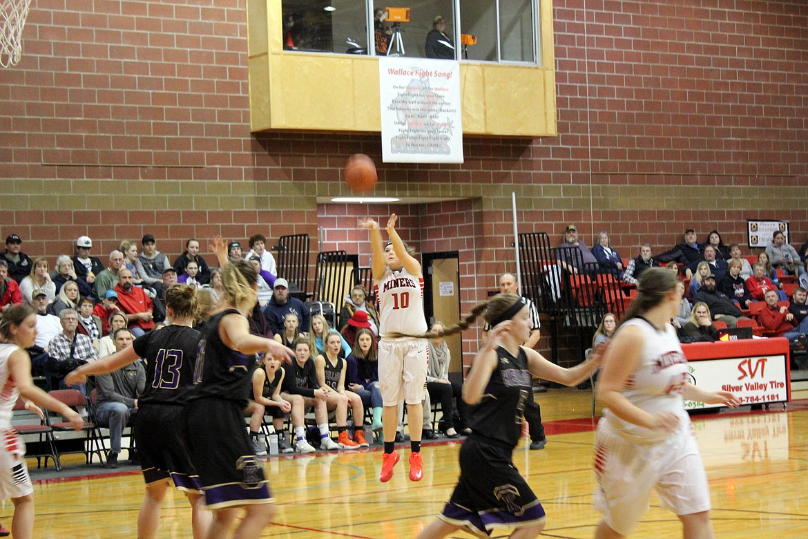 Miner Jen Hayman launches a 3-pointer during Wallace&#146;s game with Kellogg.