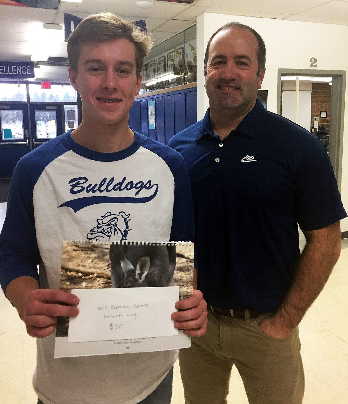 Bennette Kin, left, with Thompson Falls High School Principal Rich Ferris, accepts his finalist winnings from the Clark Fork Valley Press 2017 Reporters Contest. (Erin Jusseaume/ Clark Fork Valley Press)