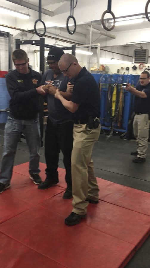 Pictured left to right are Polson Reserve Officer Michael Hingiss, Polson Police Officer Oscar Garcia, Polson Police Sergeant George Simpson, and Polson Police Officer Jim Atkins. Garcia volunteered during a Conducted Electrical Weapons training session last week. (Ashley Fox/Lake County Leader)