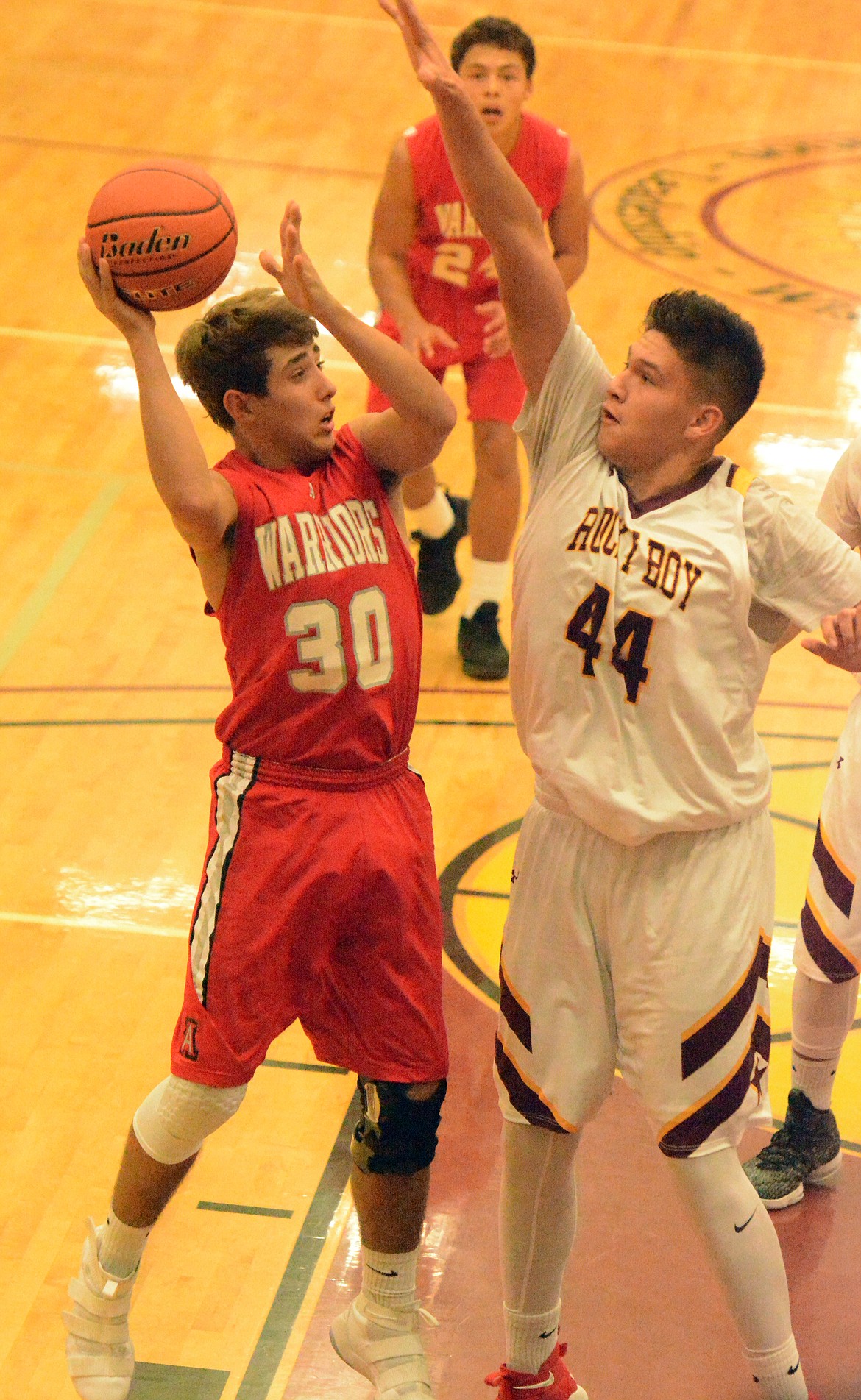 ARLEE GUARD Lane Schall shoots over a Rocky Boy defender at the Native American Classic Friday night at Joe McDonald Gym at Salish Kootenai College. (Jason Blasco/Lake County Leader)