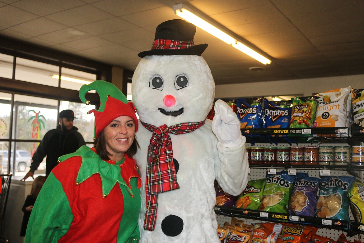 Photo by Mandi Bateman
Frosty the Snowman and an Elf at the Naples General Store, where Santa posed for pictures with children during the Naples Holiday Festival.