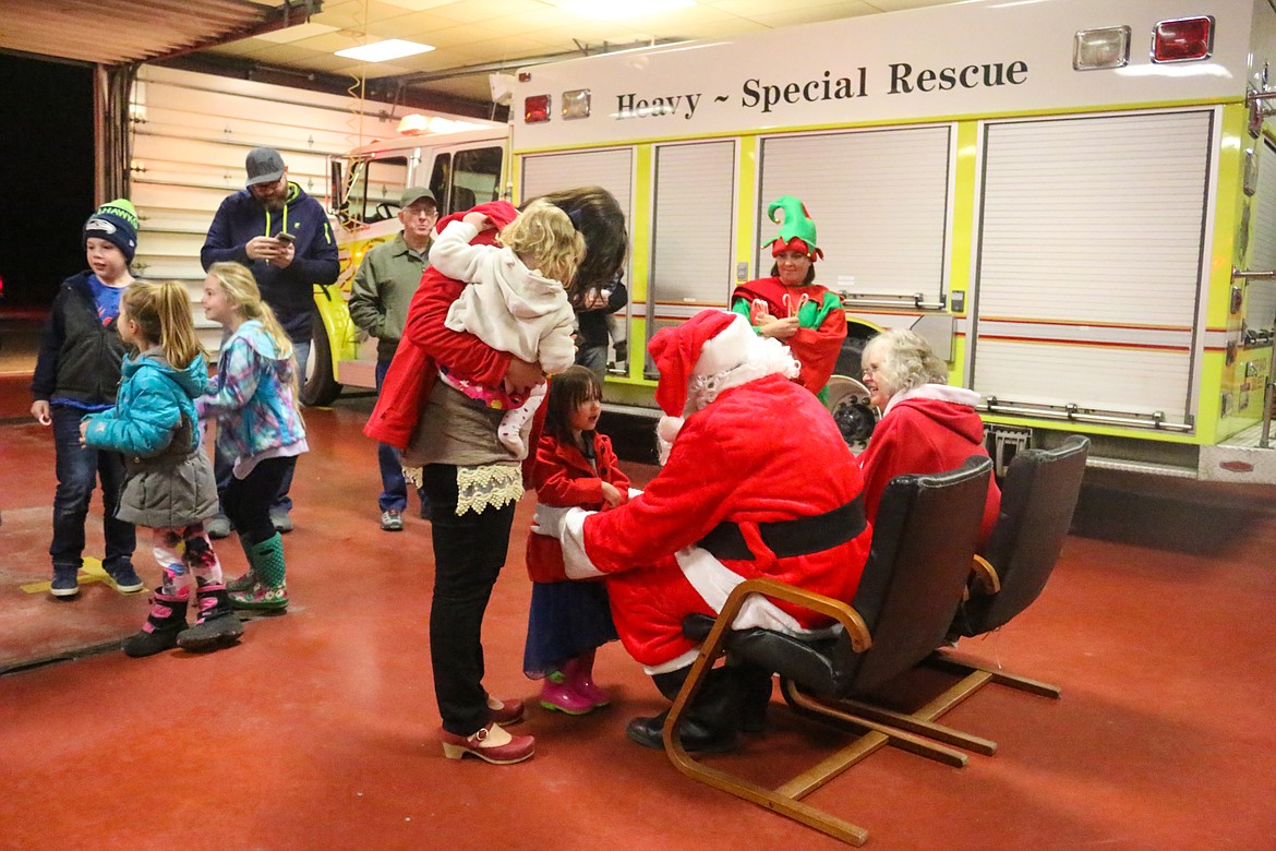 At every fire station, Santa stopped to visit with the children.