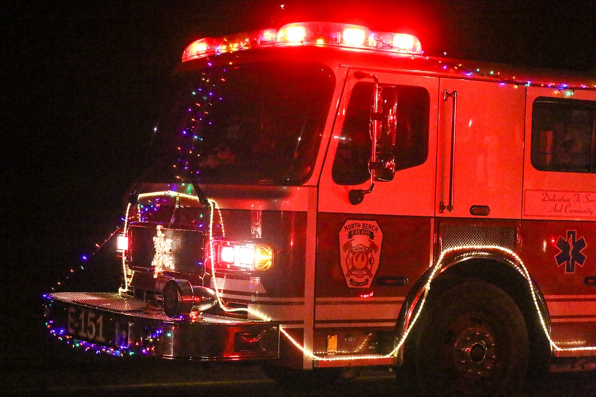 The combination of Christmas lights and emergency lights made for a bright and colorful parade, and they took Santa from fire station to fire station.