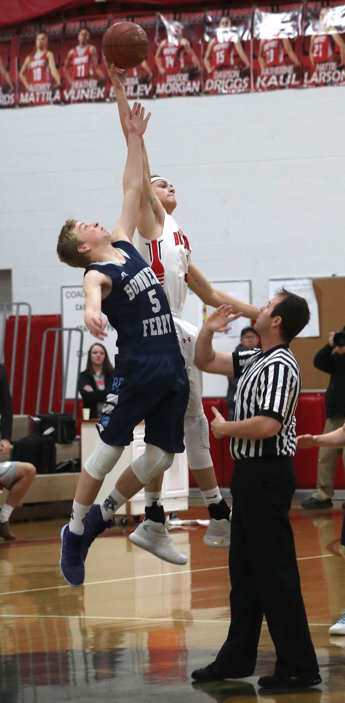 Photo by ERIC PLUMMER/Bonner County Daily Bee
Bonners Ferry&#146;s Seth Bateman (5) leaps for the opening tip against Sandpoint&#146;s 6-foot-6 T.J. Davis to begin the Badgers&#146; Saturday game in Sandpoint. Bateman scored 15 points in the contest, but the Bulldogs won 75-66.