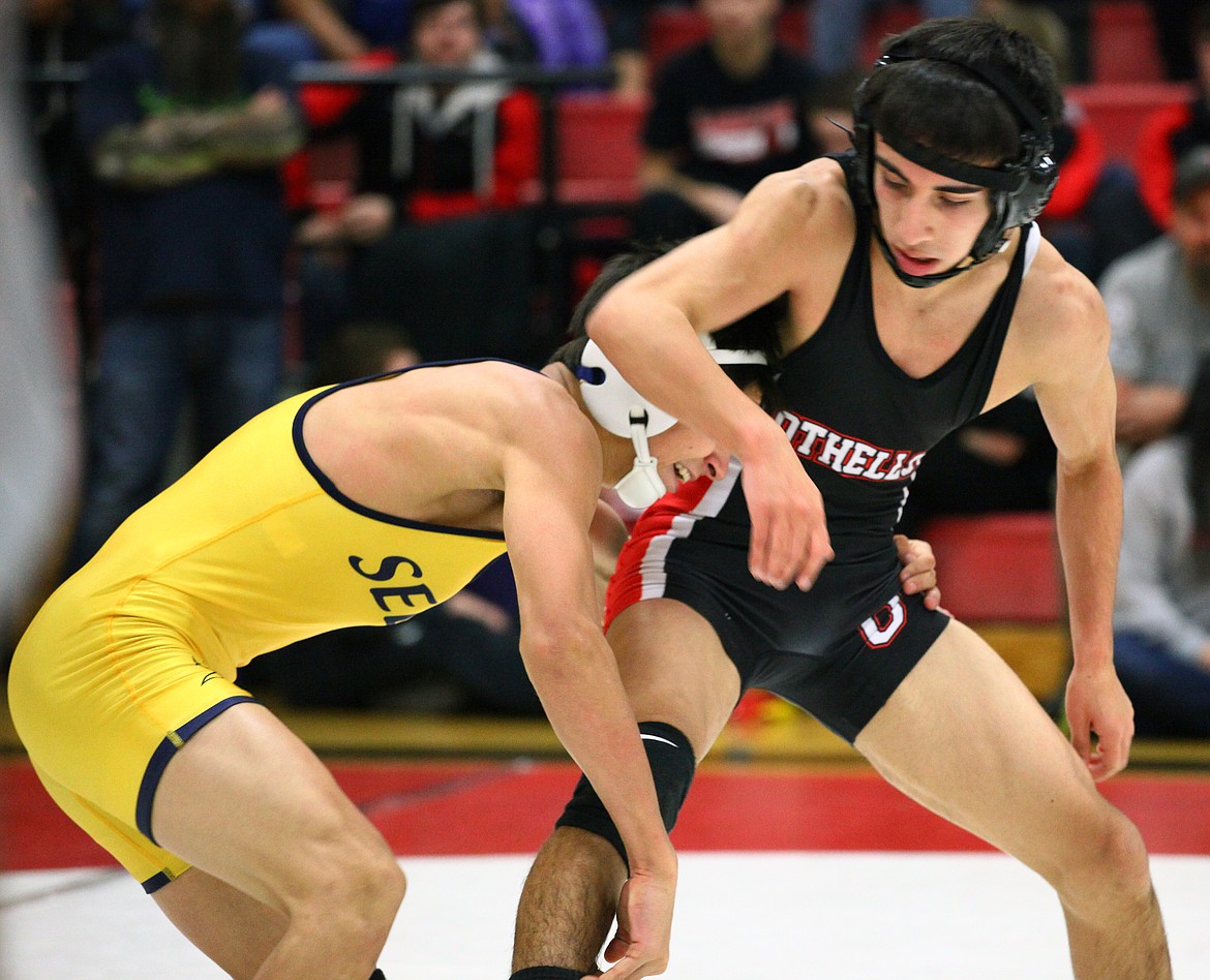 Rodney Harwood/Columbia Basin HeraldOthello senior Chris Melo, right, works against Andy Pimentel of Selah during the 113-pound championship match on Saturday at the Leonard Schutte Invitational. Melo won his second consecutive Schutte championship, 7-5.