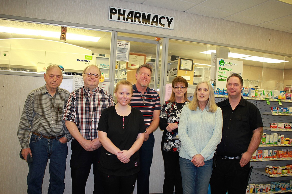 Previous Mineral Pharmacy owner (left) Herb Stelling, now 88, poses with recently retired owner Curtis Schwaderer, new technician Kami Belcher, new owner Brian Gadd, tech-in-training Terri Wasley, and cashiers Bonnie Buchanan and her son, Steve (far right). (Kathleen Woodford/Mineral Independent)