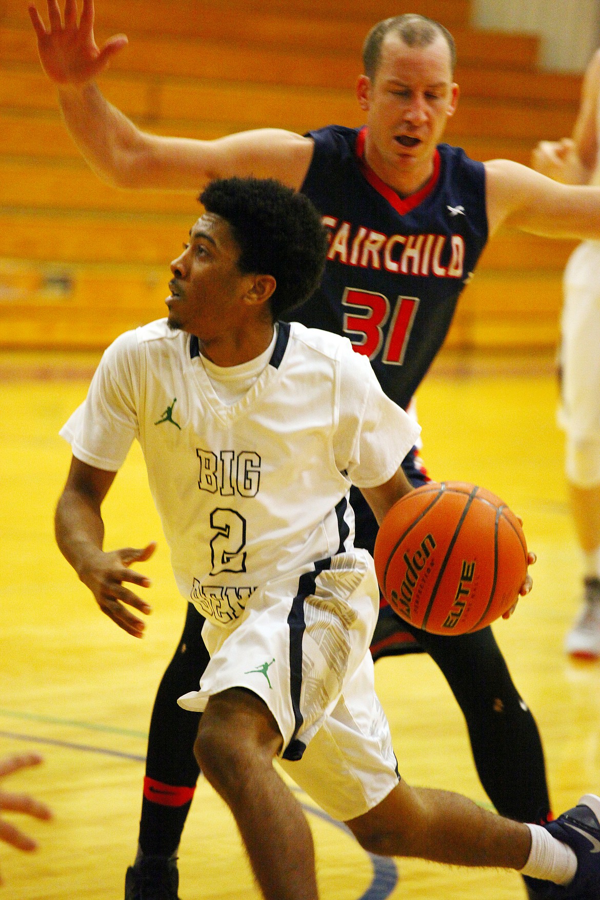 Rodney Harwood/Columbia Basin Herald
Big Bend point guard Christopher Hawkins (2) blows past Josh Sipos (31) of Fairchild AFB for the basket during first-half action Friday at DeVries Activity Center.