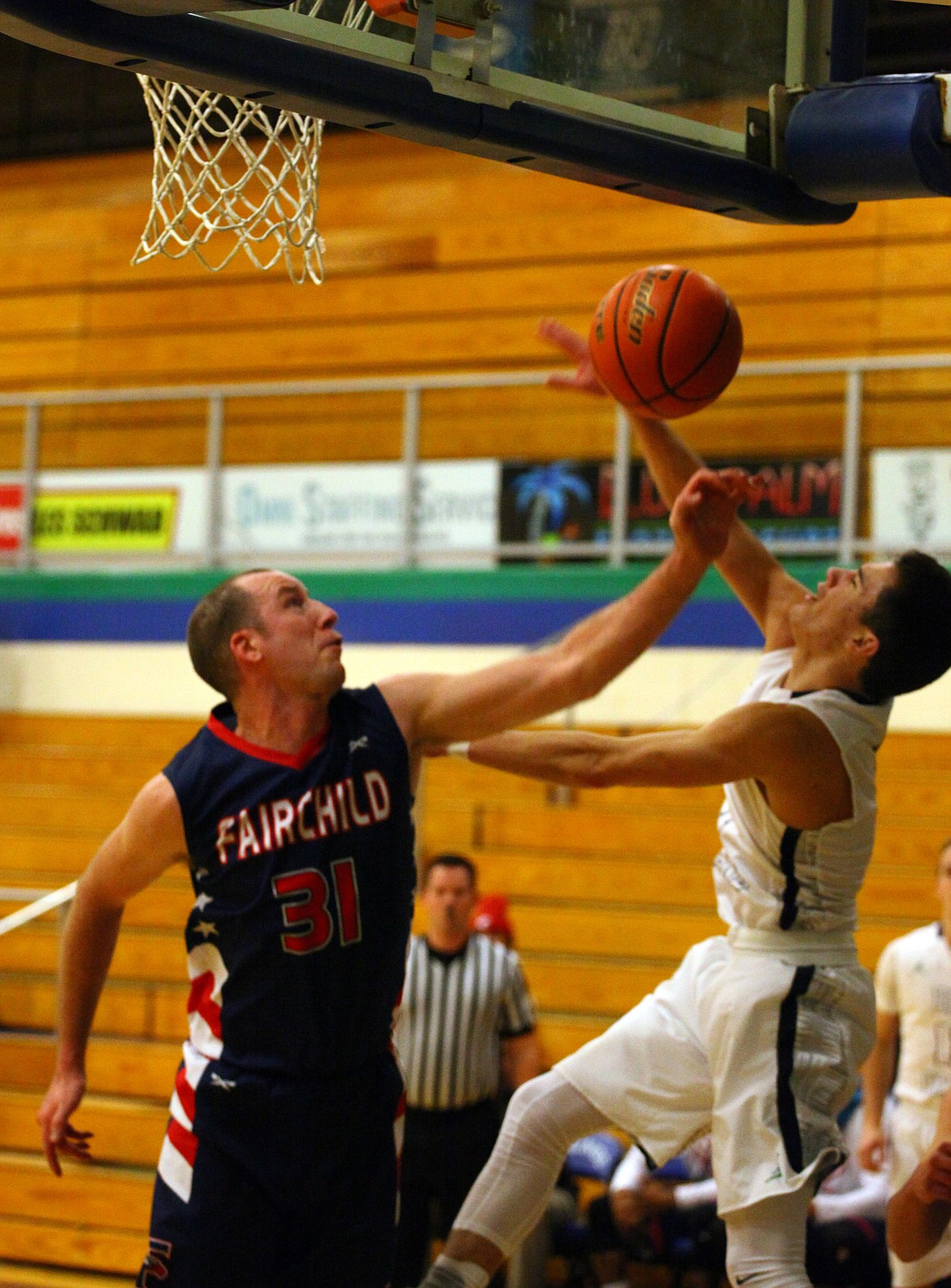 Rodney Harwood/Columbia Basin Herald
Fairchild's Josh Sipos (31) defends against Big Bend point guard Koby Huerta (1) as he slips underneath for a reverse layup during Friday night's game at DeVries Activity Center.