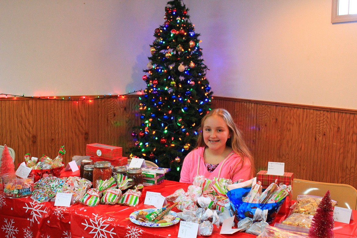 11-year-old Brooke Filek sold holiday treats at the bazaar in the St. Regis Community Center to add to her college fund for Montana State University where she wants to study to become a veterinarian. (Kathleen Woodford/Mineral Independent).