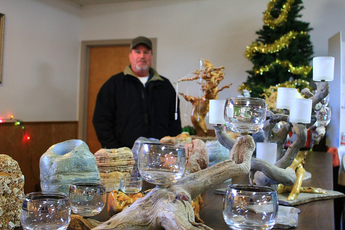 Kirk Bruce recently moved into the area and had a table of stones drilled out to be a vase, planter or even a candle holder at the holiday bazaar in St. Regis last Saturday. (Kathleen Woodford/Mineral Independent).