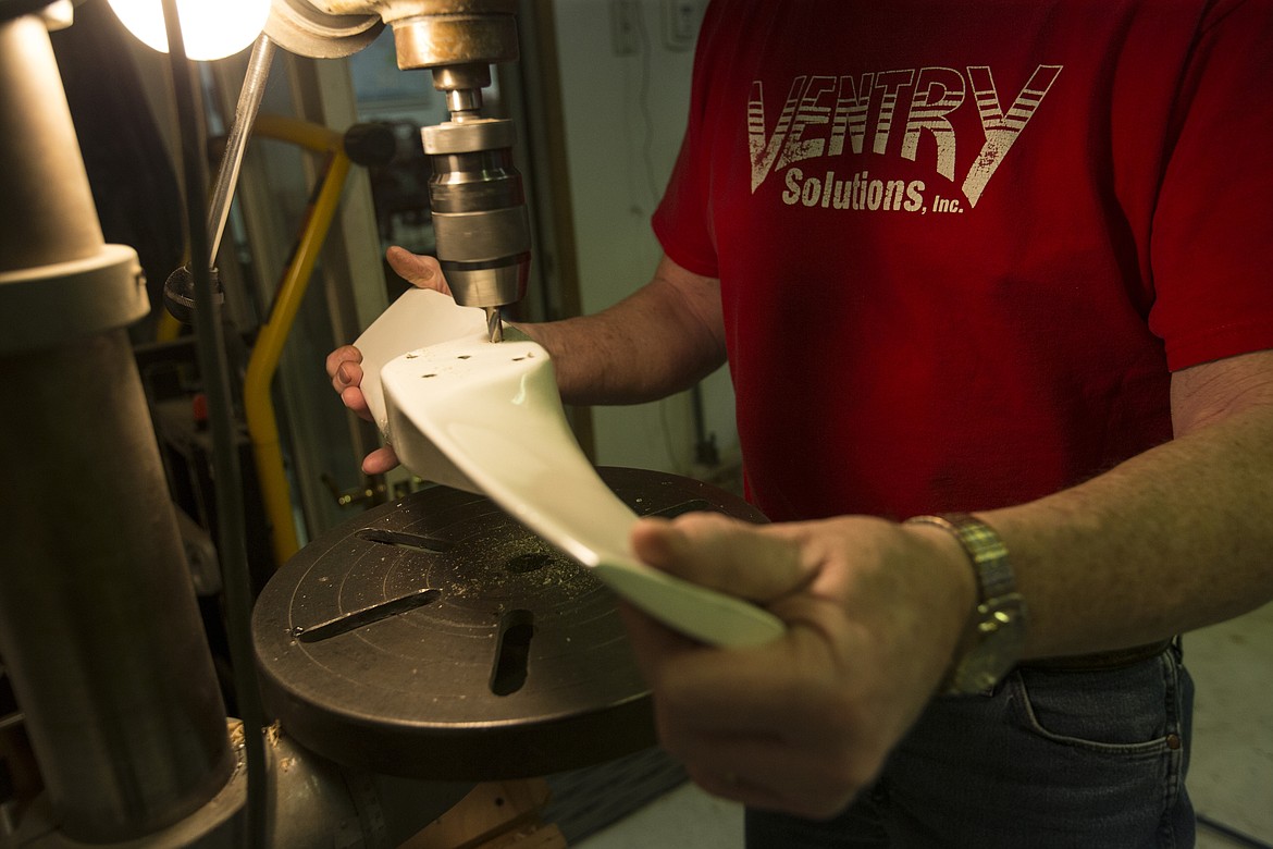 LOREN BENOIT/NIBJ
Ken Birge drills holes in a propeller at Ventry in Hauser Lake. The patented kevlar-fiberglass-wood composite propellers made with red cedar are light and safe and are cut with a machine at the business.