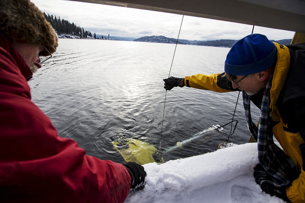 Marty Mueller, co-founder of Gizmo CDA, left, and Craig Lysk help lower a remotely operated vehicle into Lake Coeur d'Alene to test its thrusters and other instruments in preparation for a dive into Lake Pend Oreille next year. (LOREN BENOIT/Press)