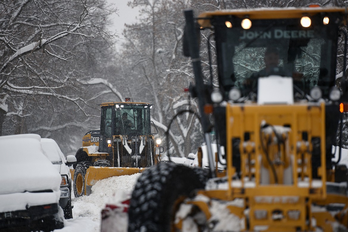 Snow plows clear 2nd Avenue East at 3rd Street East in Kalispell on Thursday. (Casey Kreider/Daily Inter Lake)