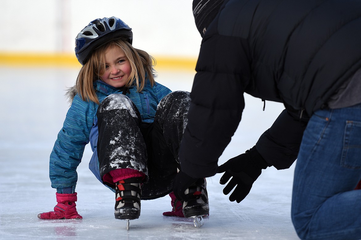 Ella Counts gets some help with her skate from Mark Freidline, Recreation Superintendent with Kalispell Parks and Recreation, while ice skating at Woodland Park during Kalispell Parks and Recreation Freeze Out Camp on Tuesday. (Casey Kreider/Daily Inter Lake)