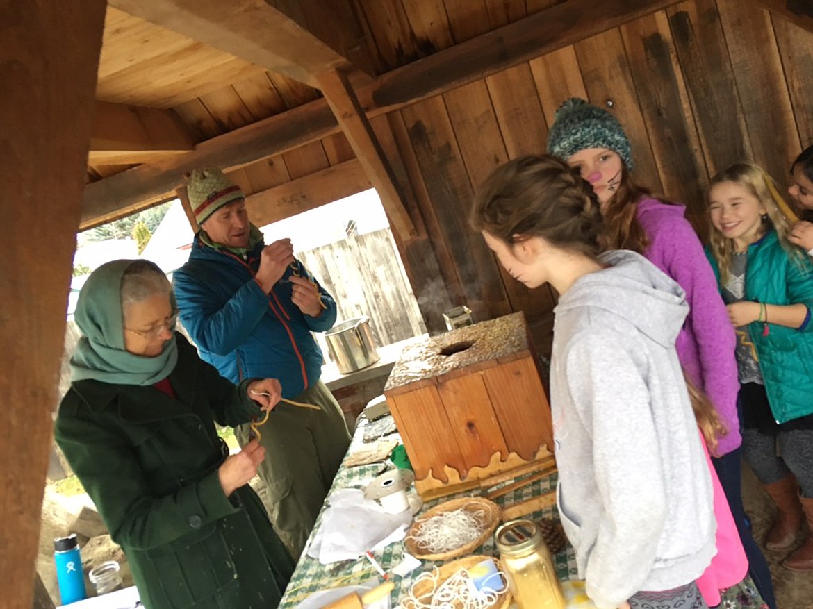 (Photo courtesy KATIE COX)Beeswax candle dipping is a popular station at the Sandpointn Waldorf School's annual Christmas Faire.