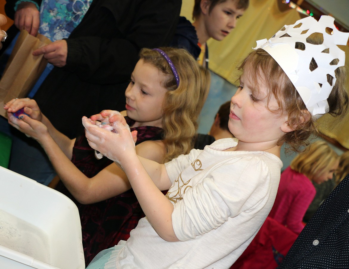 (Photo by CAROLINE LOBSINGER)Sandpoint Waldorf students make soap to give as Christmas gifts during the school's annual Christmas Faire.