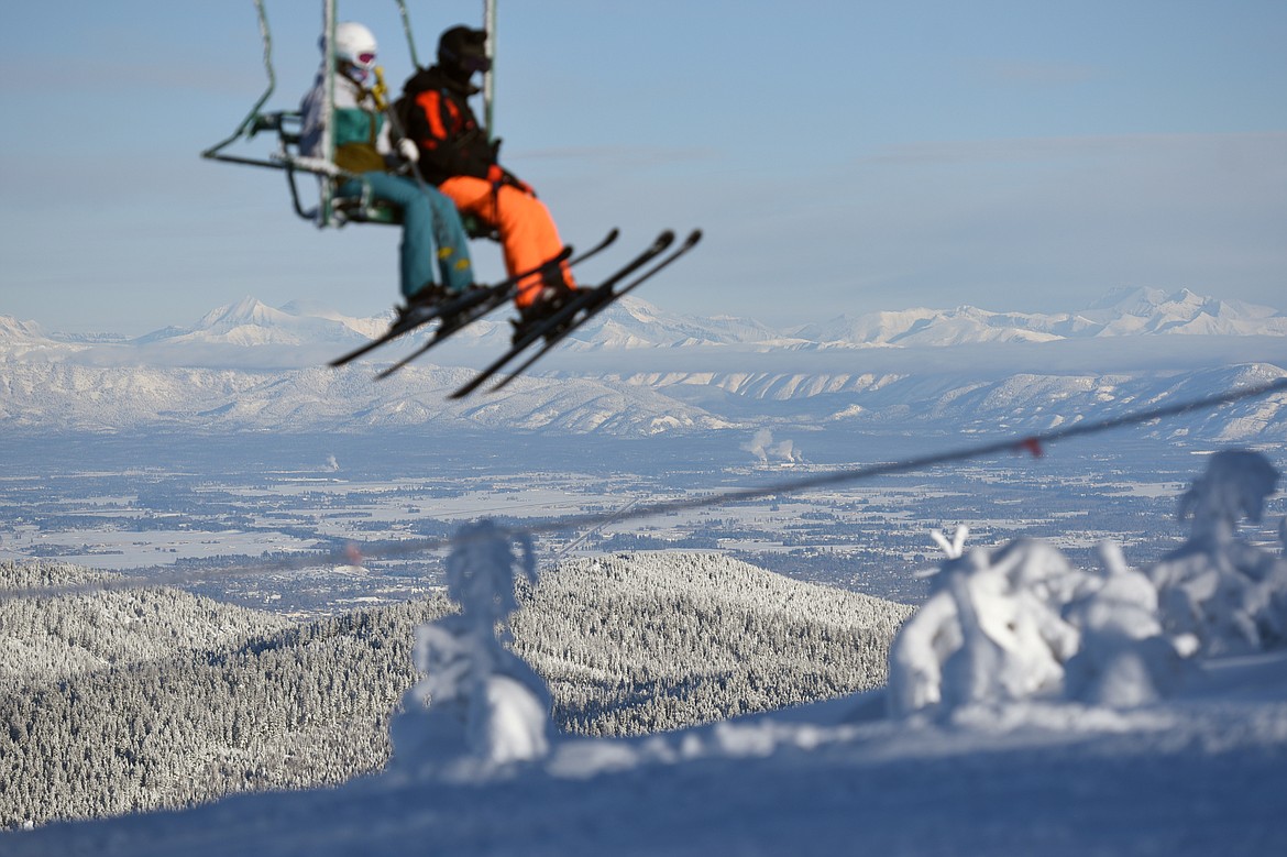 A pair of skiers ride the Olympic Triple Chair lift at Blacktail Mountain Ski Area&#146;s opening day Saturday, Dec. 23. (Casey Kreider/Daily Inter Lake)