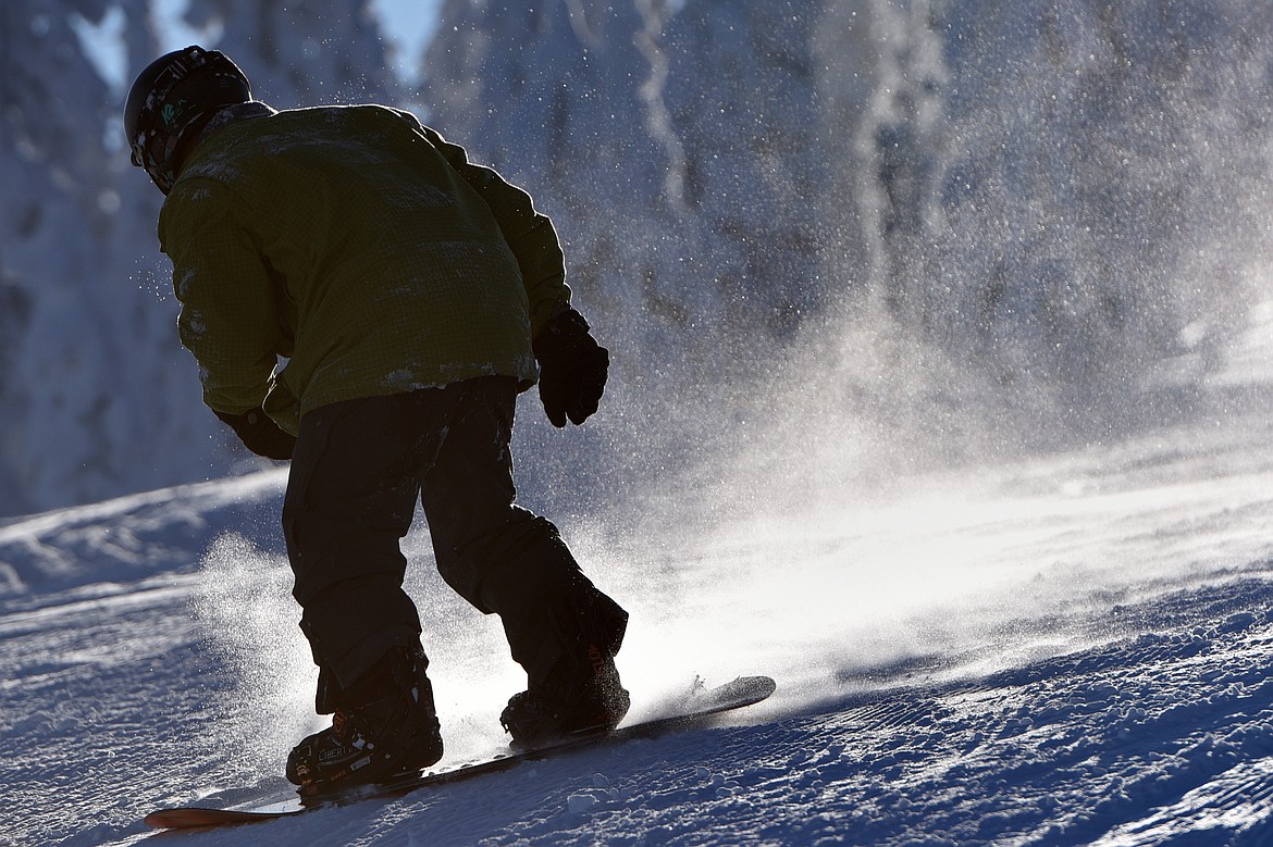 A snowboarder takes a run down the Meadow Trail at Blacktail Mountain Ski Area&#146;s opening day Saturday, Dec. 23.  (Casey Kreider/Daily Inter Lake)