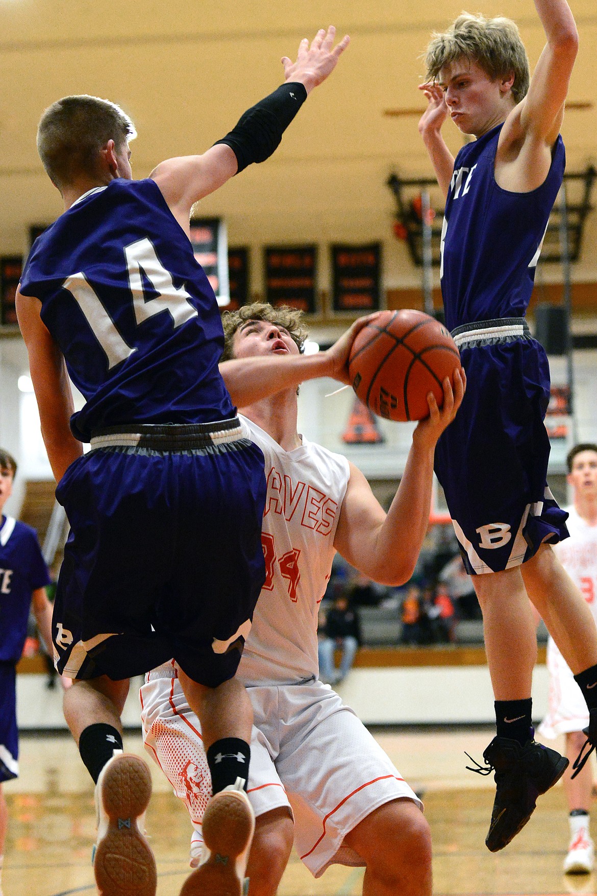 Flathead&#146;s Andrew Siderius gets Butte defenders Trevyn Roth (14) and Clay Ferguson in the air before dropping in two points. (Casey Kreider/Daily Inter Lake)