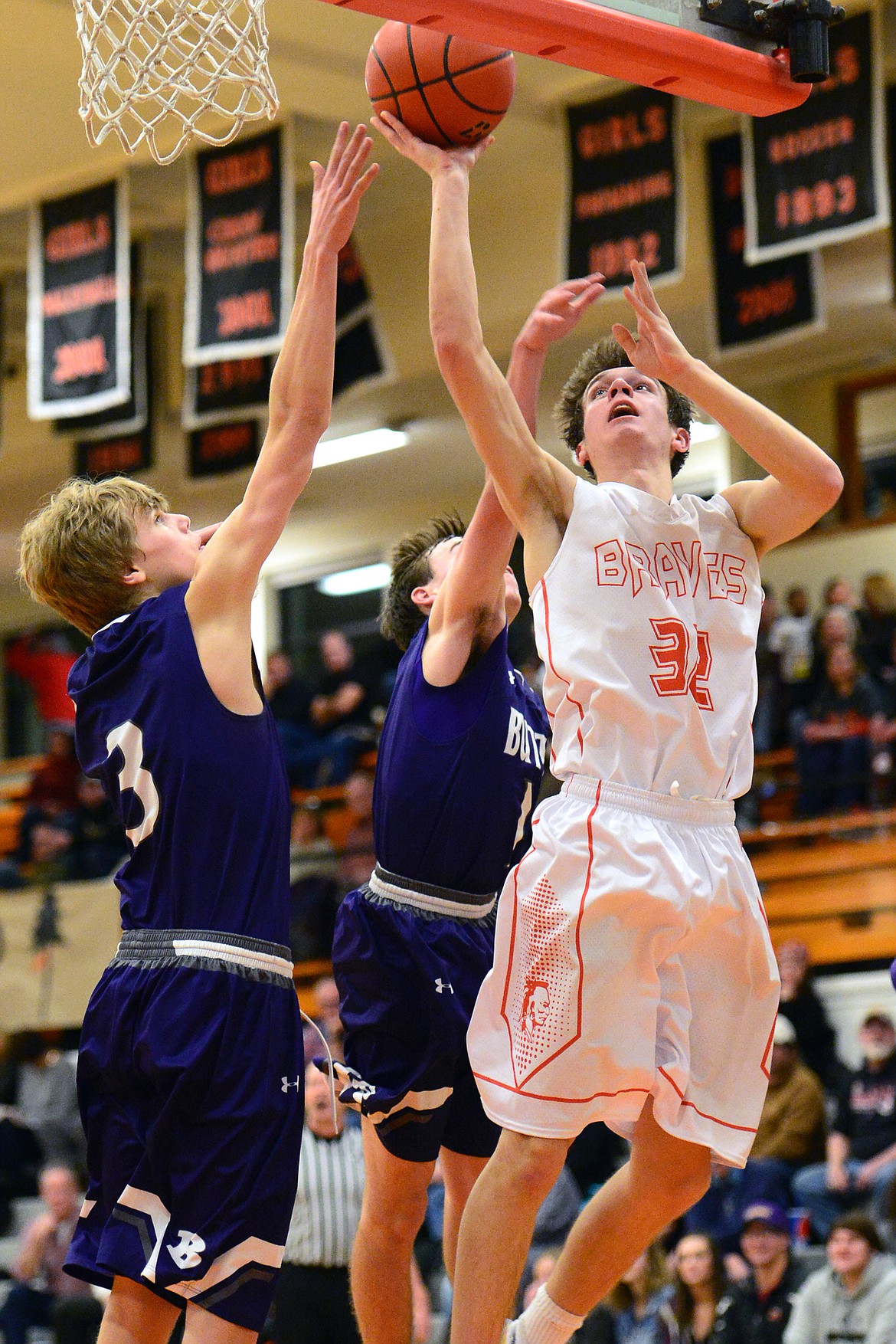 Flathead&#146;s Tyler Johnson lays in two points with Butte&#146;s Clay Ferguson (3) and Kash Kelly (1) defending. (Casey Kreider/Daily Inter Lake)