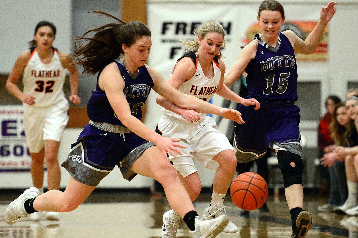 Flathead&#146;s Kaysie Malmin (11) battles Butte&#146;s Haley Herron (32) and Justise Birkenbuel (15) for a loose ball. (Casey Kreider/Daily Inter Lake)