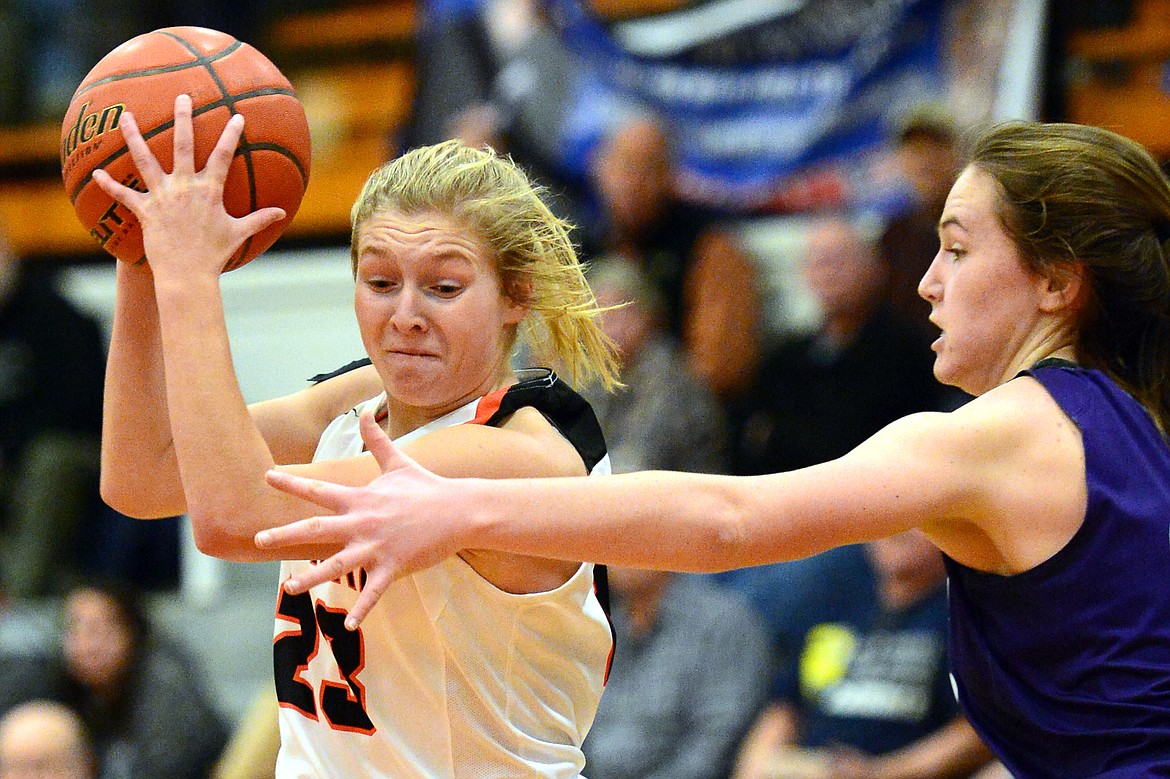 Flathead&#146;s Clara Vandenbosch drives to the hoop on Butte defender Haley Herron. (Casey Kreider/Daily Inter Lake)