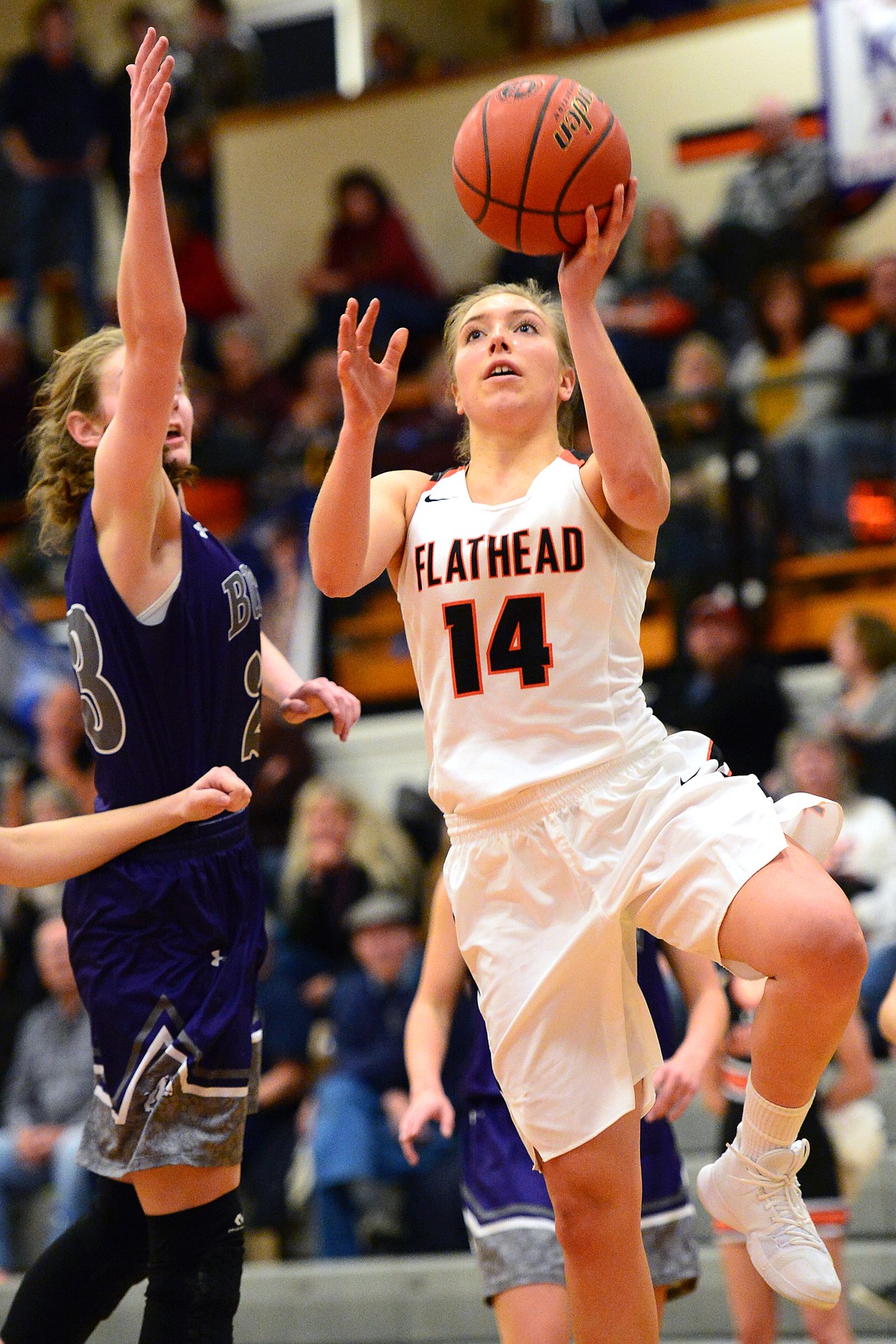 Flathead&#146;s Mary Heaton drives to the hoop past Butte&#146;s Kira Mortensen. (Casey Kreider/Daily Inter Lake)