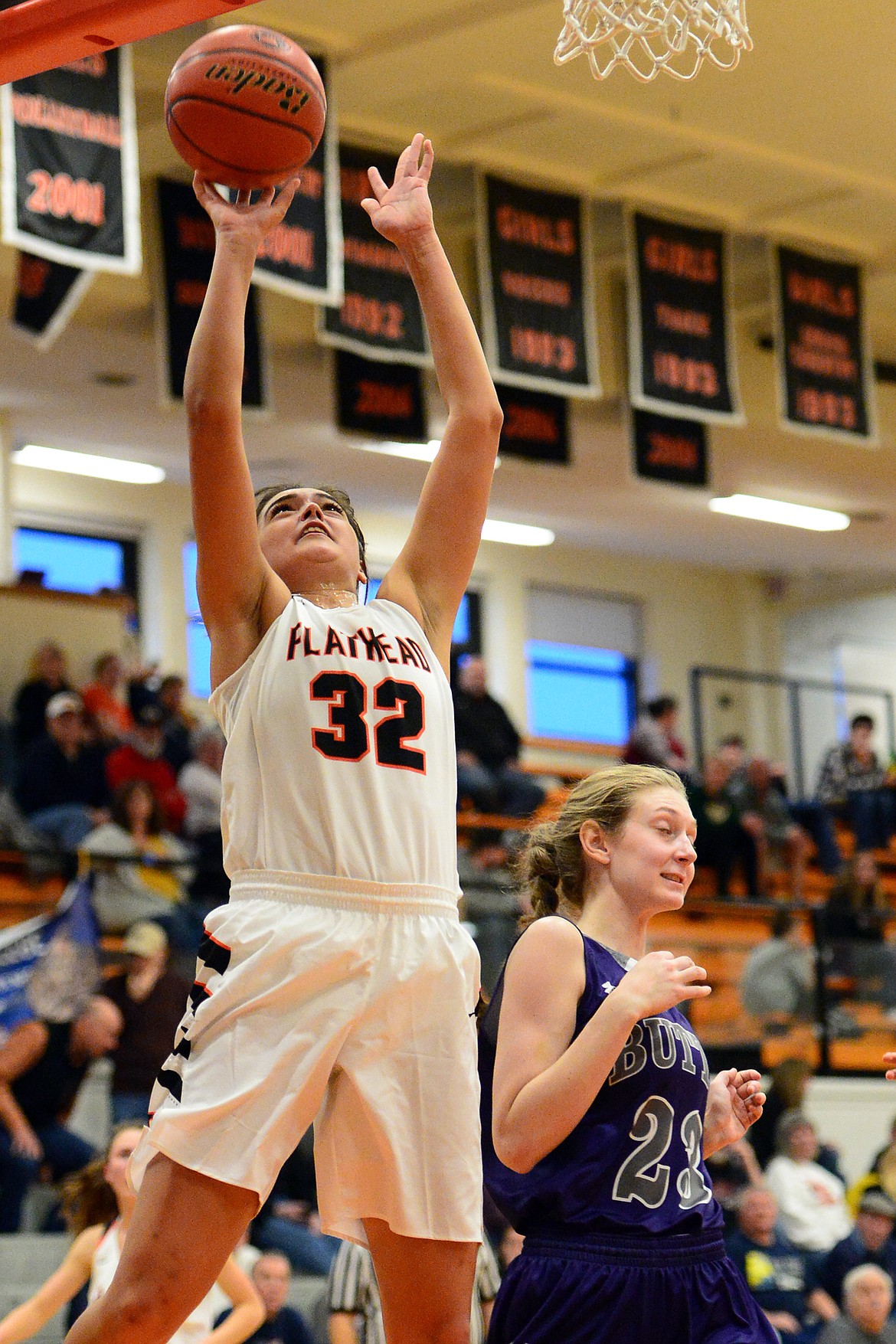 Flathead&#146;s Taylor Henley goes to the hoop in front of Butte defender Kira Mortensen. (Casey Kreider/Daily Inter Lake)