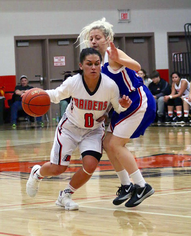 RONAN MAIDENS guard Micalann McCrea drives to the basket against a Columbia Falls defender during Saturday night's game against the Lady Wildkatz at the Ronan Events Center. (Photo by Teagan Gray/Special to the Lake County Leader)