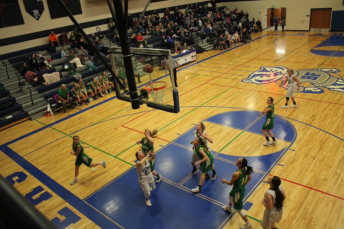 Photo by Tanna Yeoumans
Holly Ansley shoots for gold as the Lakeland defense waits for a rebound.