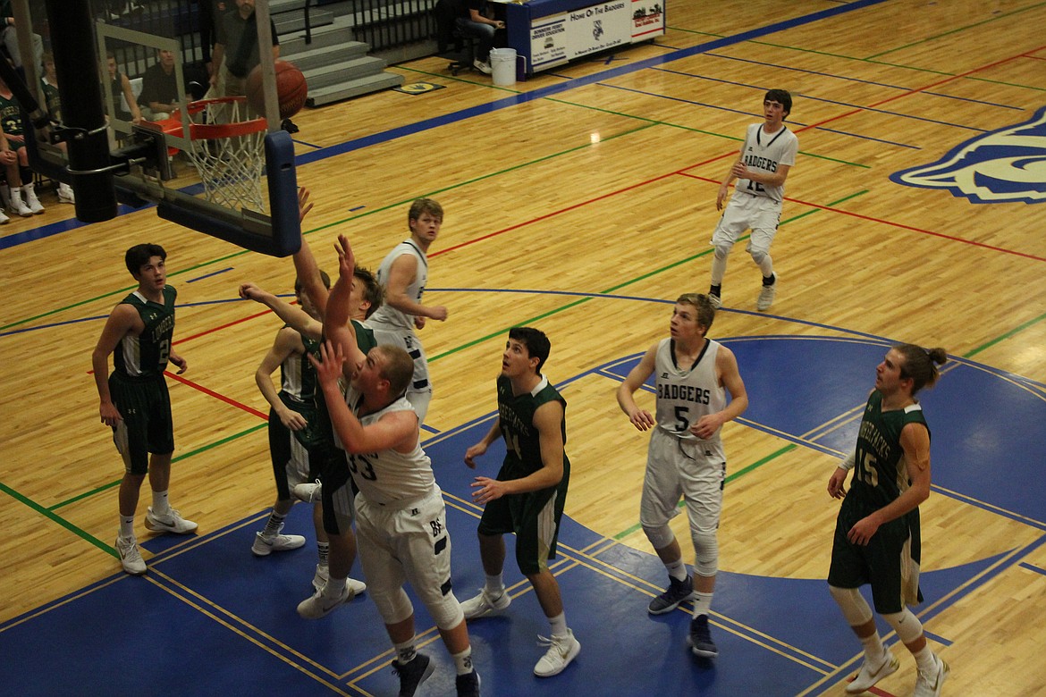 Photo by Tanna Yeoumans
The Badger boys and the St. Maries team standoff at the basket.