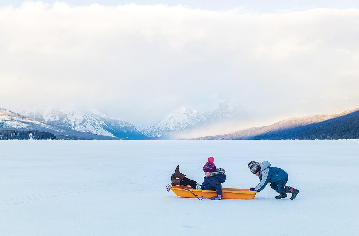 Sledding on a frozen Lake McDonald.  (Chris Peterson photo)