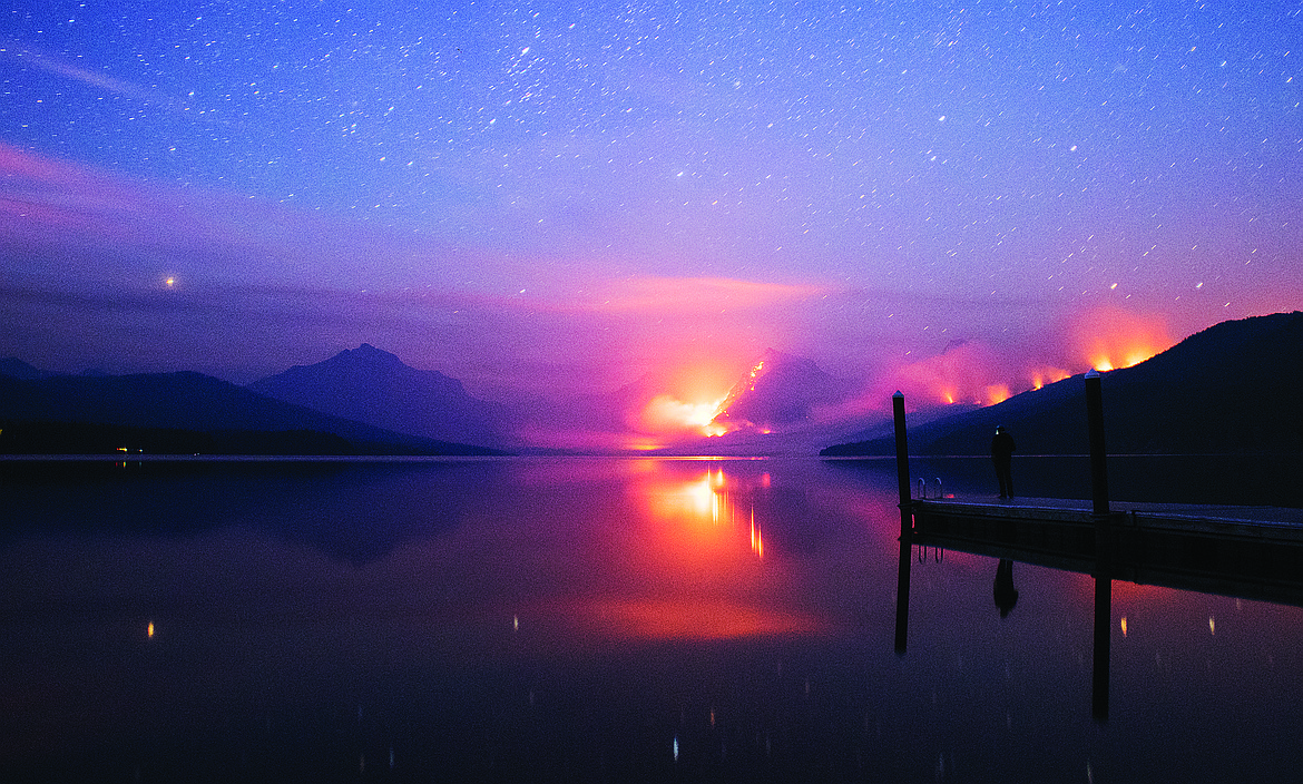 Stars glow over Lake McDonald as the Sprague Fire burns.  (Chris Peterson photo)