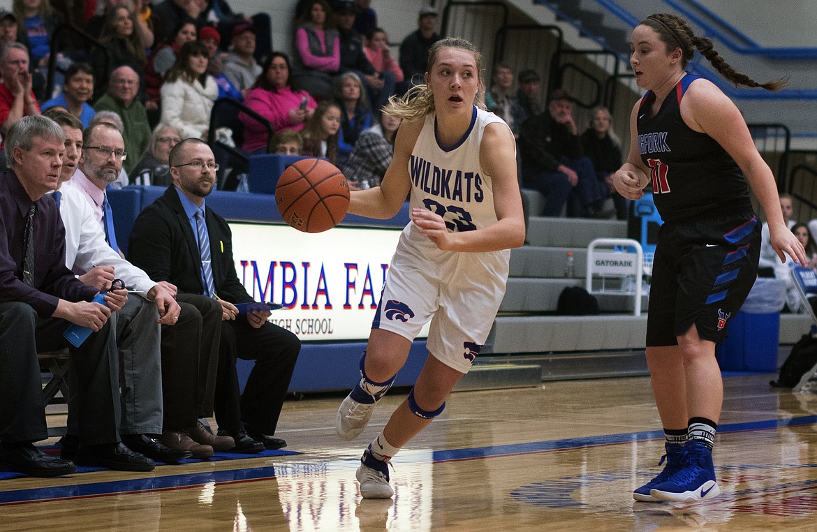 Ryley Kehr drives through the Bigfork defense as he coaches look on from the sideline. Kehr finished with a game-high 20 points. (Jeremy Weber photo)