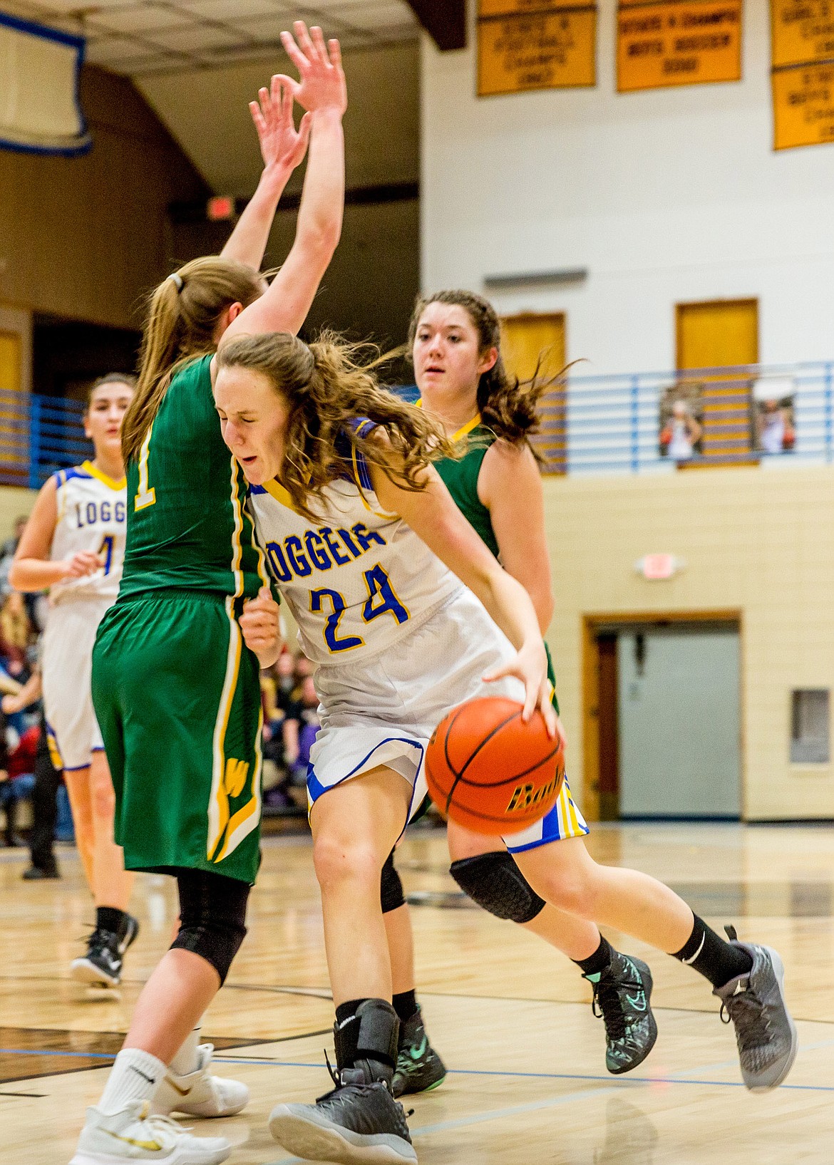 Libby's Jayden Winslow pushes past Whitefish's Kit Anderson Thursday in Libby. (John Blodgett/The Western News)