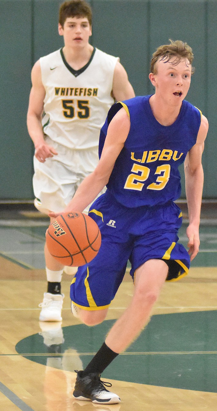 Logger Junior Ryggs Johnston takes the ball down court on a fast break during Thursday night's game against the Bulldogs at Whitefish High School. (Heidi Desch/Whitefish Pilot)