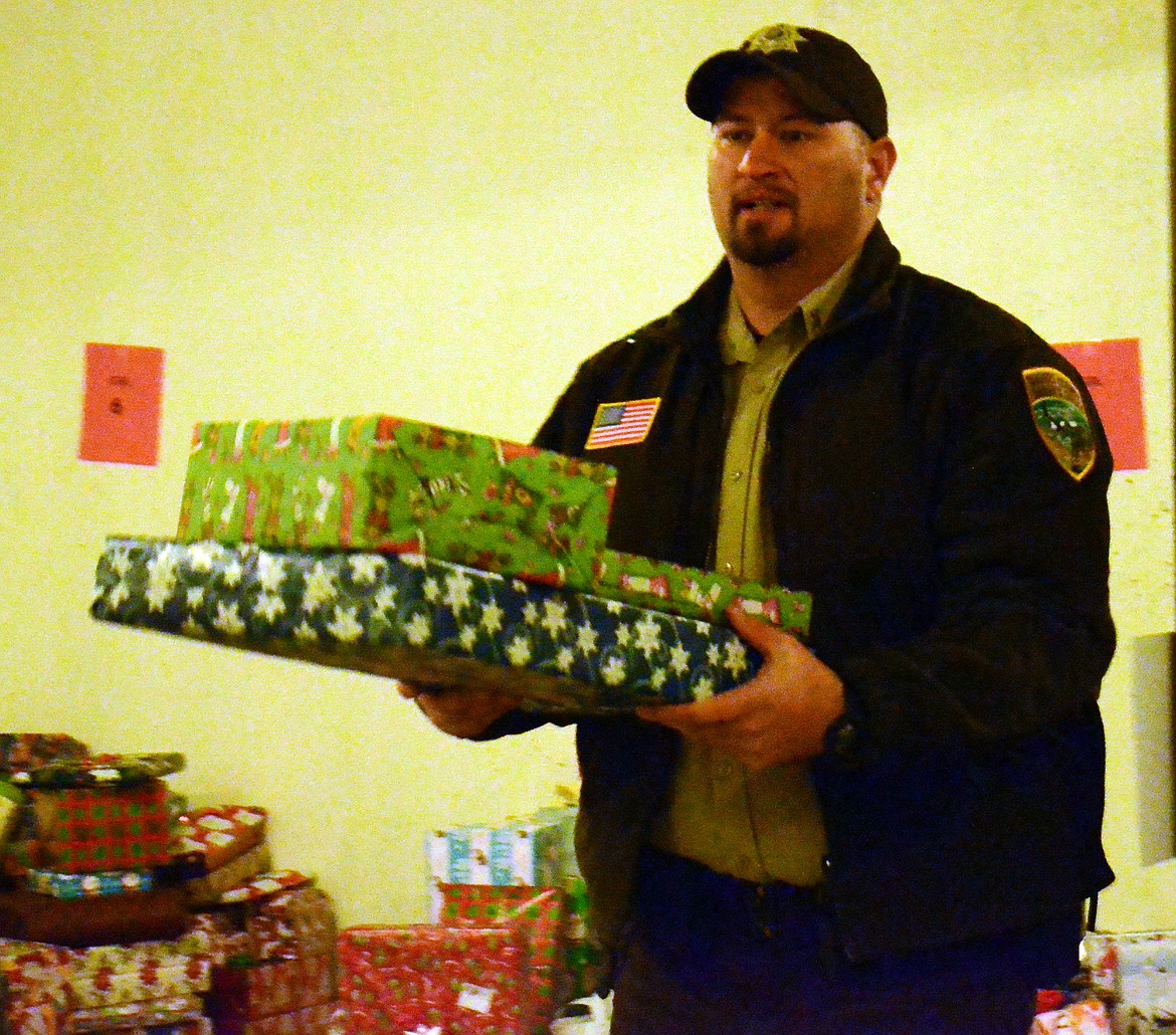 Deputy Elliot drops off the last few presents collected from around Sanders County. (Erin Jusseaume/ Clark Fork Valley Press)