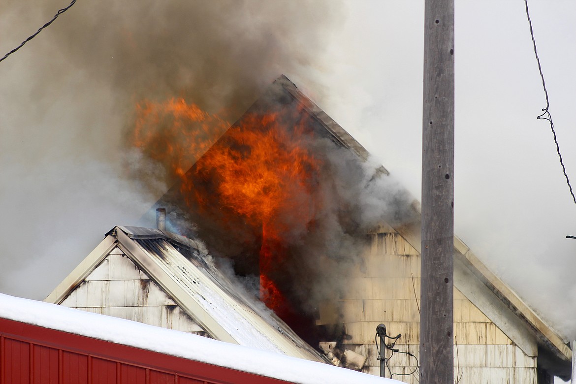 Photo by CHANSE WATSON
Flames roll out of the roof on the south side of the residence on Cypress St. in Wallace. Allegedly starting in the basement, the fire quickly rose and spread through the rest of the house.