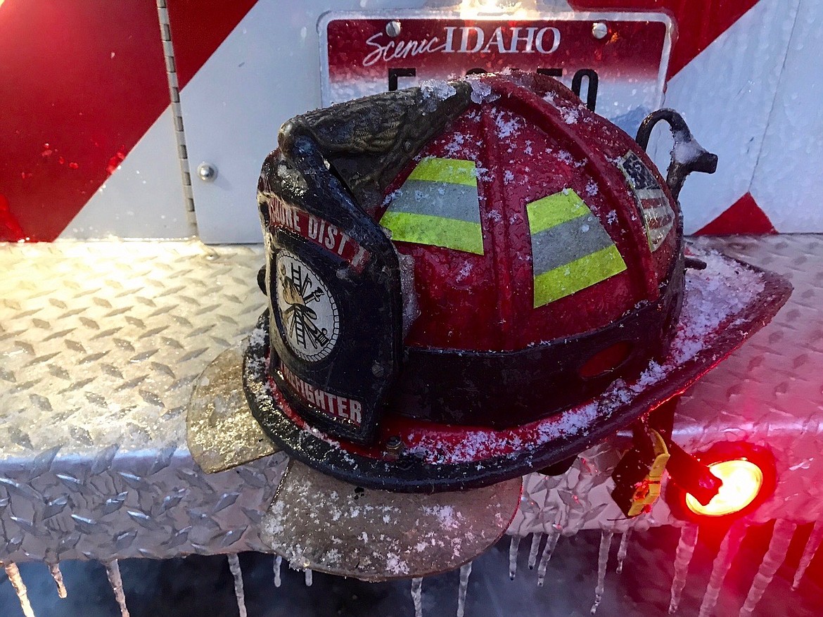 Photo courtesy of John Miller/ 
It sure was cold out their! Firefighter Miller shows off a fire helmet with an impressive layer of ice on it.