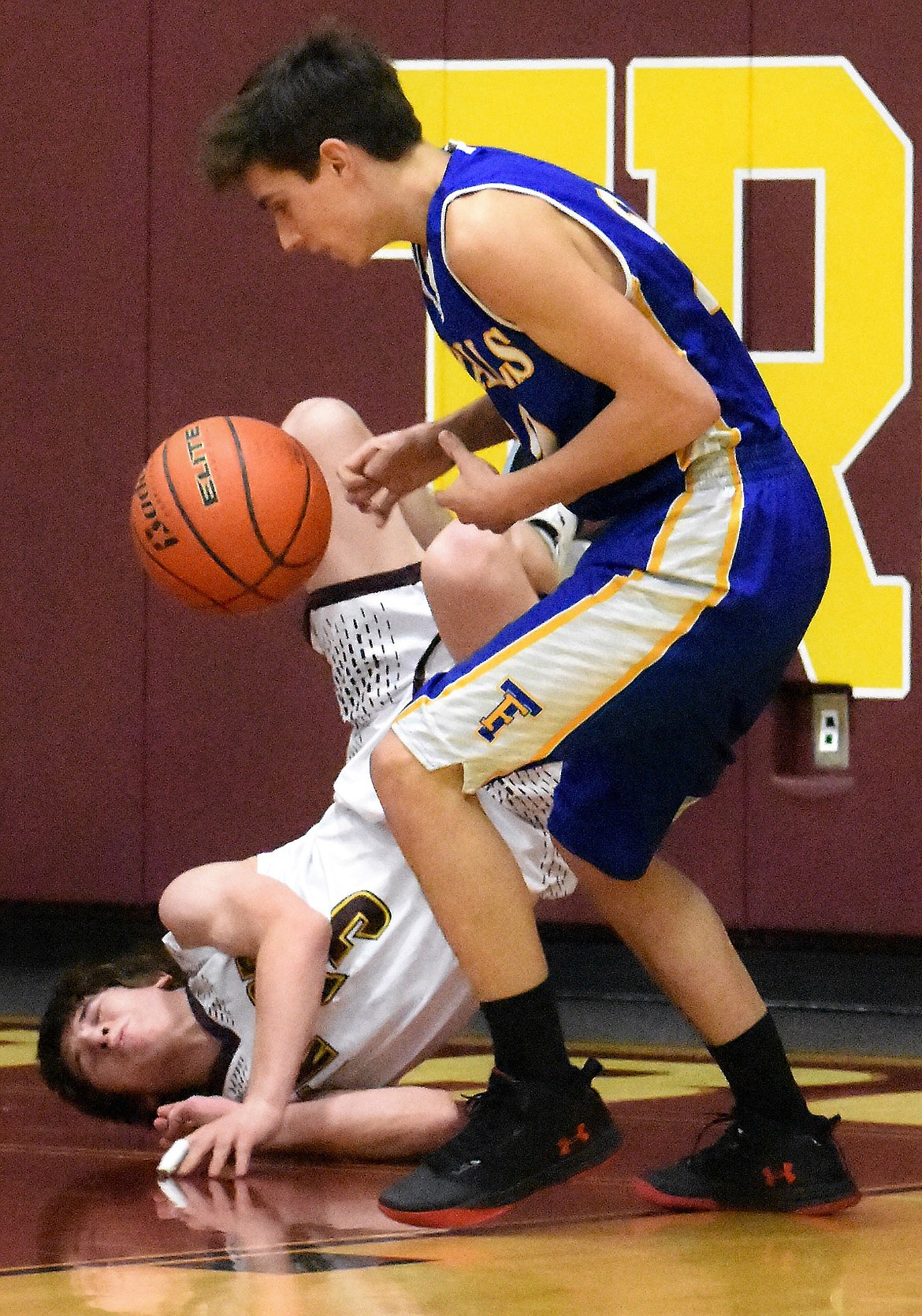 Troy's Trevor Hoagland falls after being prevented from scoring against Thompson Falls Thursday. (Photo by Svetlana Harper)