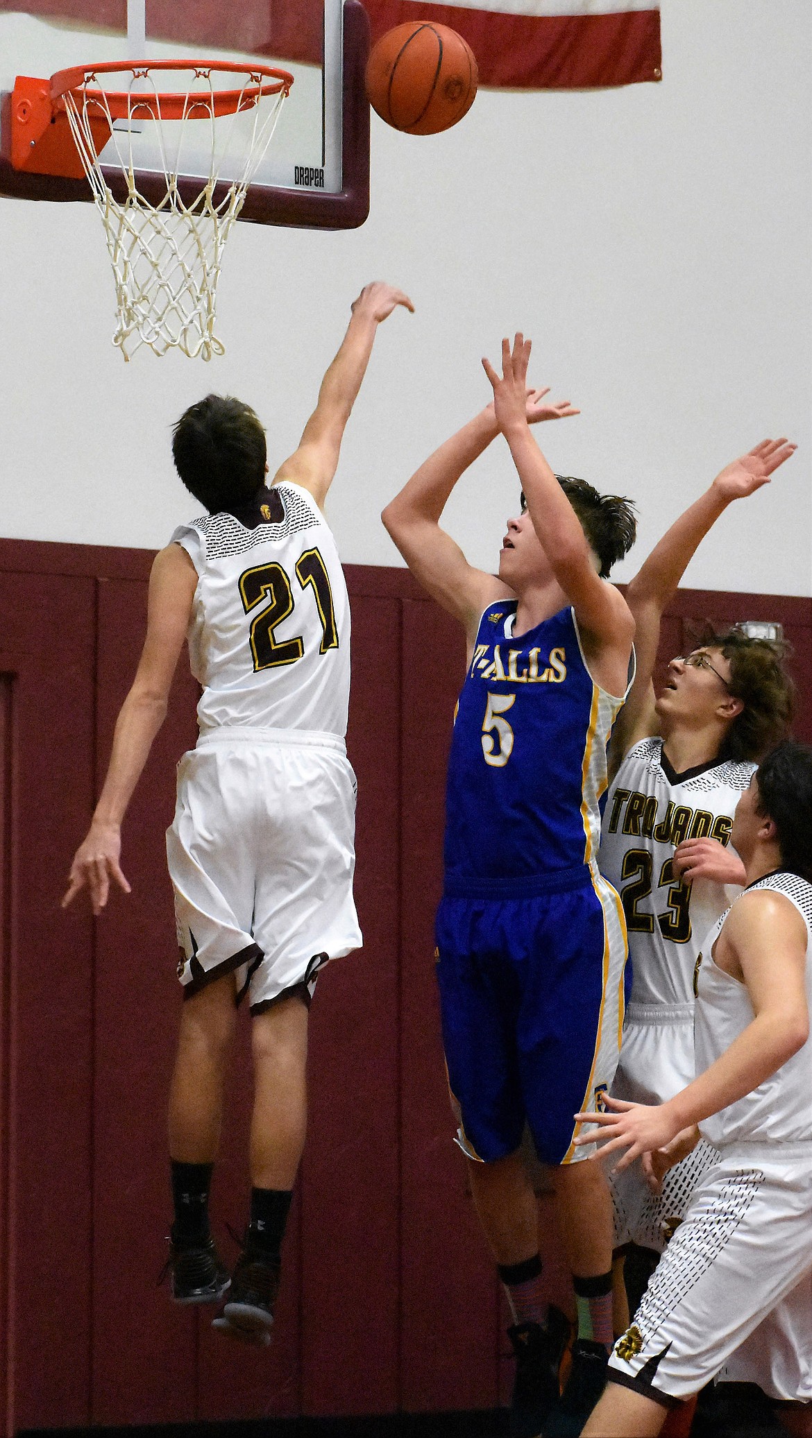 Troy's Dylan Cummings blocks a shot by Danny Hoisington of Thompson Falls Thursday. (Photo by Svetlana Harper)