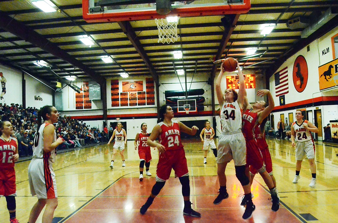 Rachel Huenik (34) plows through the Scarlet defense to land a basket for the Trotters (Erin Jusseaume/ Clark Fork Valley Press)