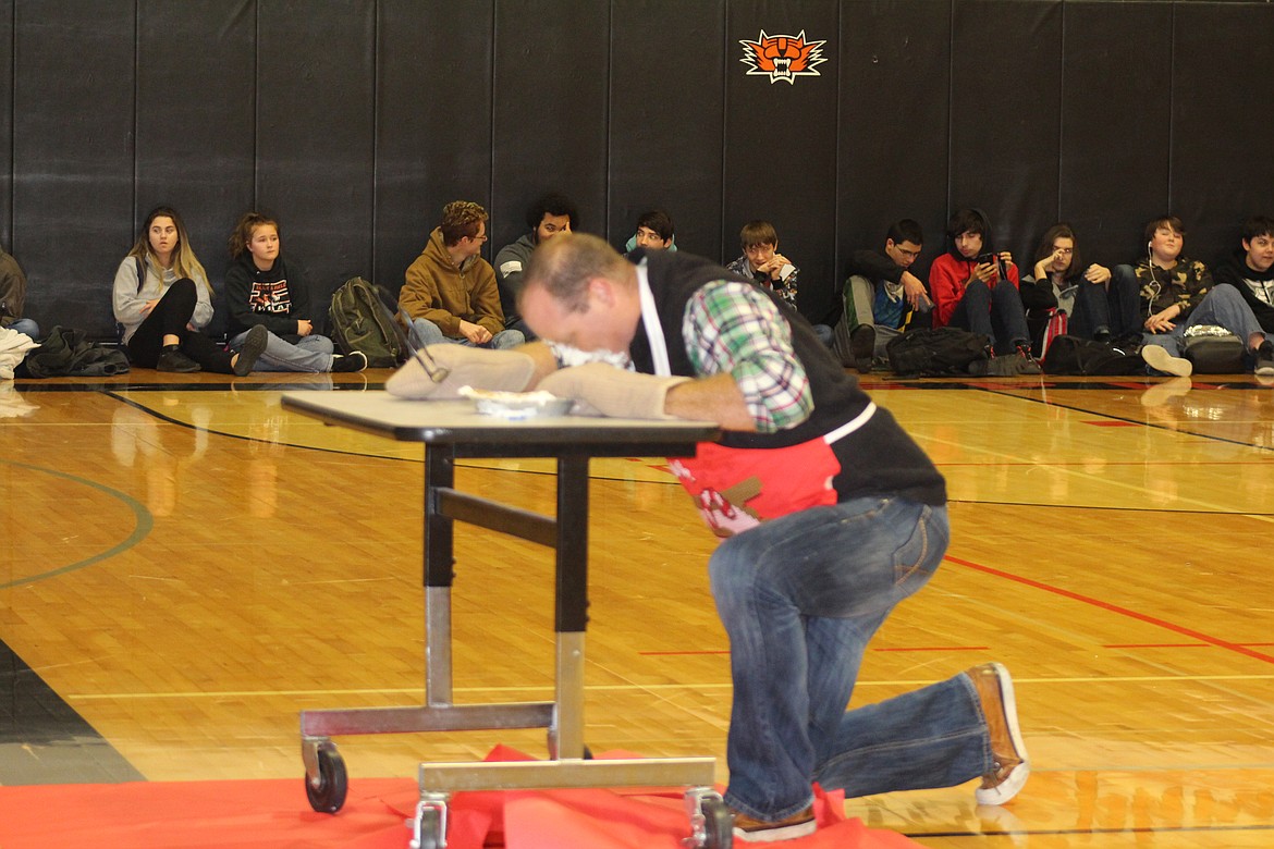 Cheryl Schweizer/Columbia Basin Herald
Ephrata High School teacher Tobin Springs searches through a whipped cream pie &#8211; with no hands &#8211; at the annual Toys for Teens challenge. The obstacle course was the culmination of the annual EHS charitable project.