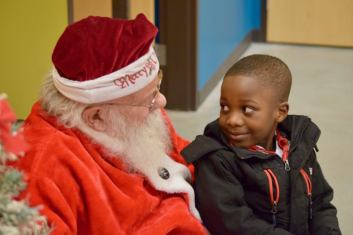 Charles H. Featherstone/Columbia Basin Herald
A boy talks with Santa Jack at the Boys &amp; Girls Club&#146;s McGraw Clubhouse in Moses Lake on Tuesday afternoon.