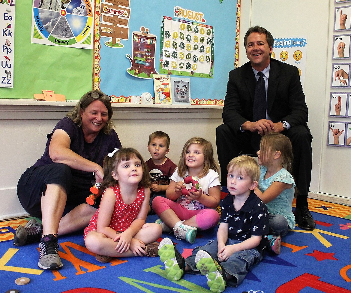 Governor Bullock Visits Alberton Preschool, Sept. 6: Montana Gov. Steve Bullock poses with Alberton&#146;s first-ever preschool class on Aug. 31. From left to right are teacher Sue Dallapiazza, Ryan Johns, Carson Gardener, Amity Evans, Leland Norris and Sadie Powell. (Kathleen Woodford/Mineral Independent).