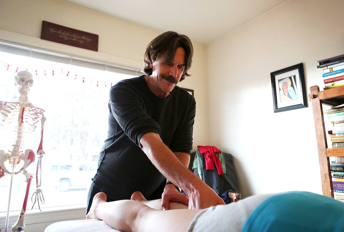 Certified Rolfer John Barton works on Cor Colbert of Whitefish at his Whitefish office. Rolfing sessions typically last around 75 minutes and Rolfers recommend patients undergo a series of 10 treatments, each of which targets one area of the body, for best results. (Mackenzie Reiss/Flathead Journal)