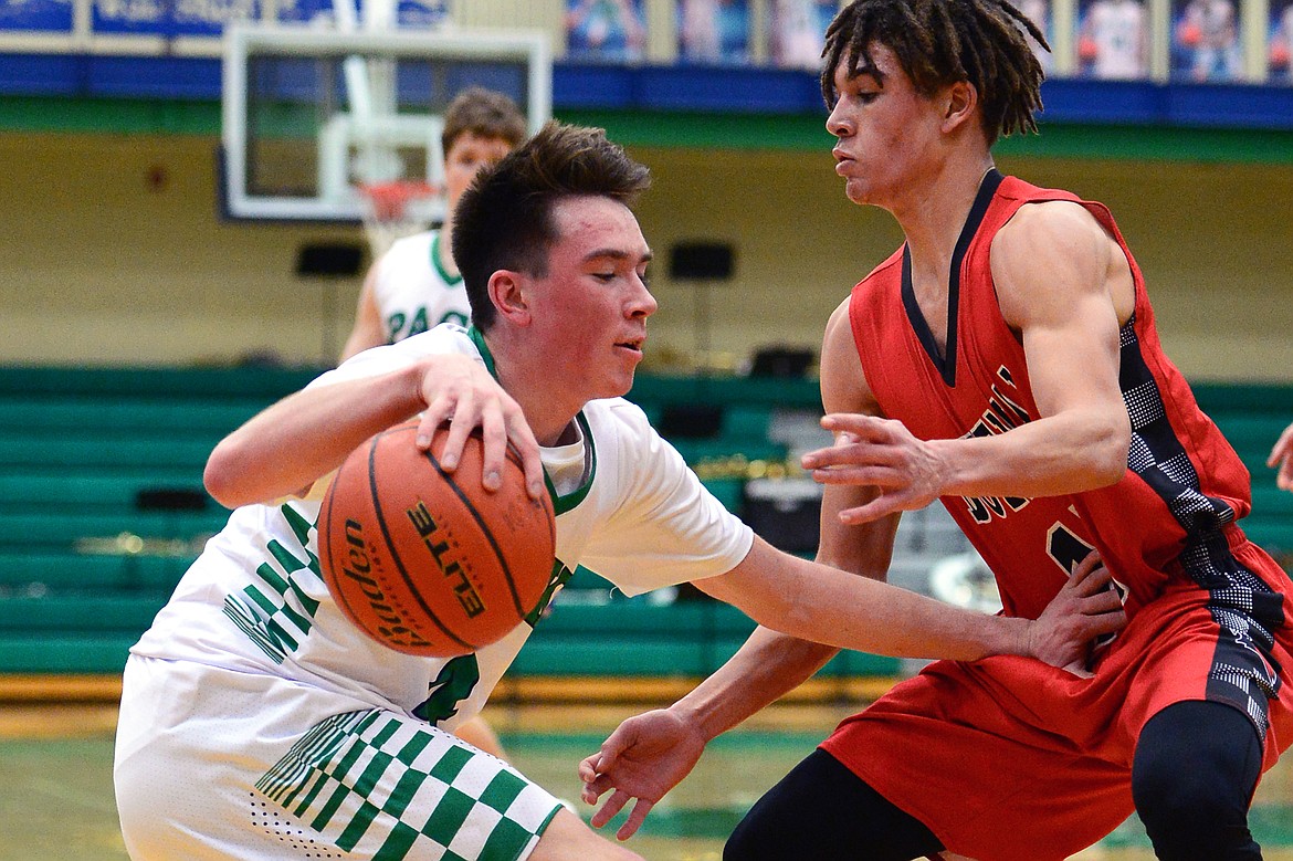 Glacier's Collin Kazmier is defended by Bozeman's Latrell McCutcheon. (Casey Kreider/Daily Inter Lake)