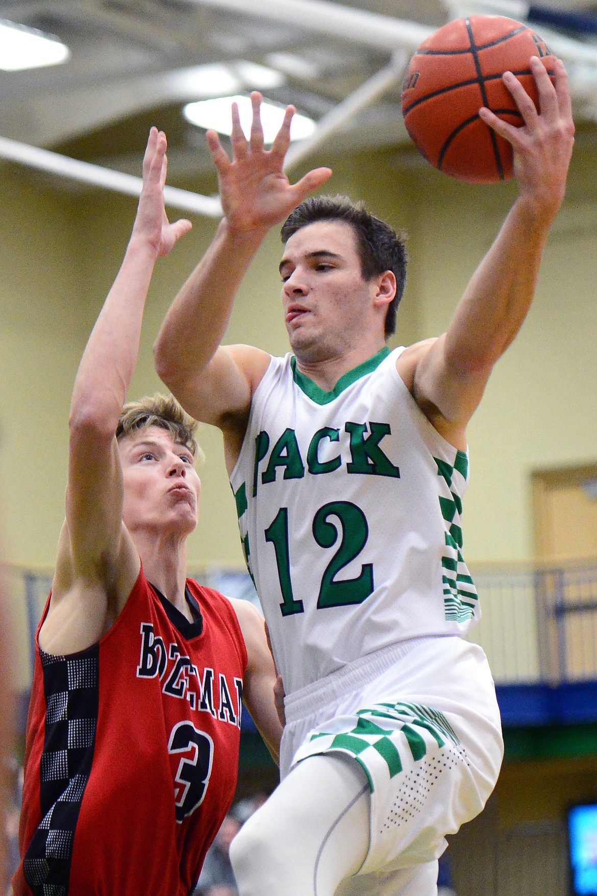 Glacier's Kody Jarvis drives to the hoop past Bozeman's Ryan Simpson. (Casey Kreider/Daily Inter Lake)