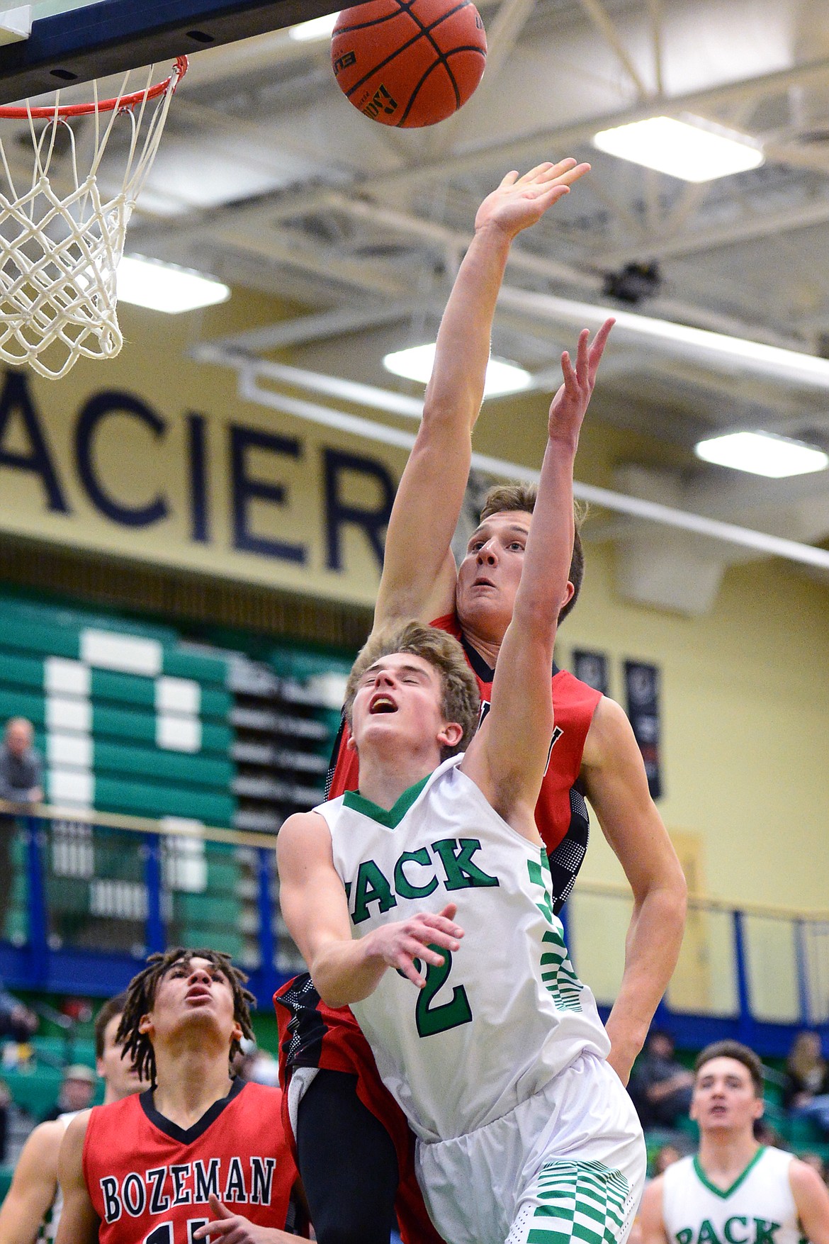 Glacier's Caden Harkins is fouled on his way to the hoop by Bozeman's Ryan Lonergan. (Casey Kreider/Daily Inter Lake)