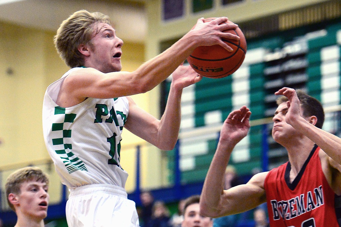 Glacier's Brec Rademacher drives to the hoop with Bozeman's Mack Anderson defending. (Casey Kreider/Daily Inter Lake)